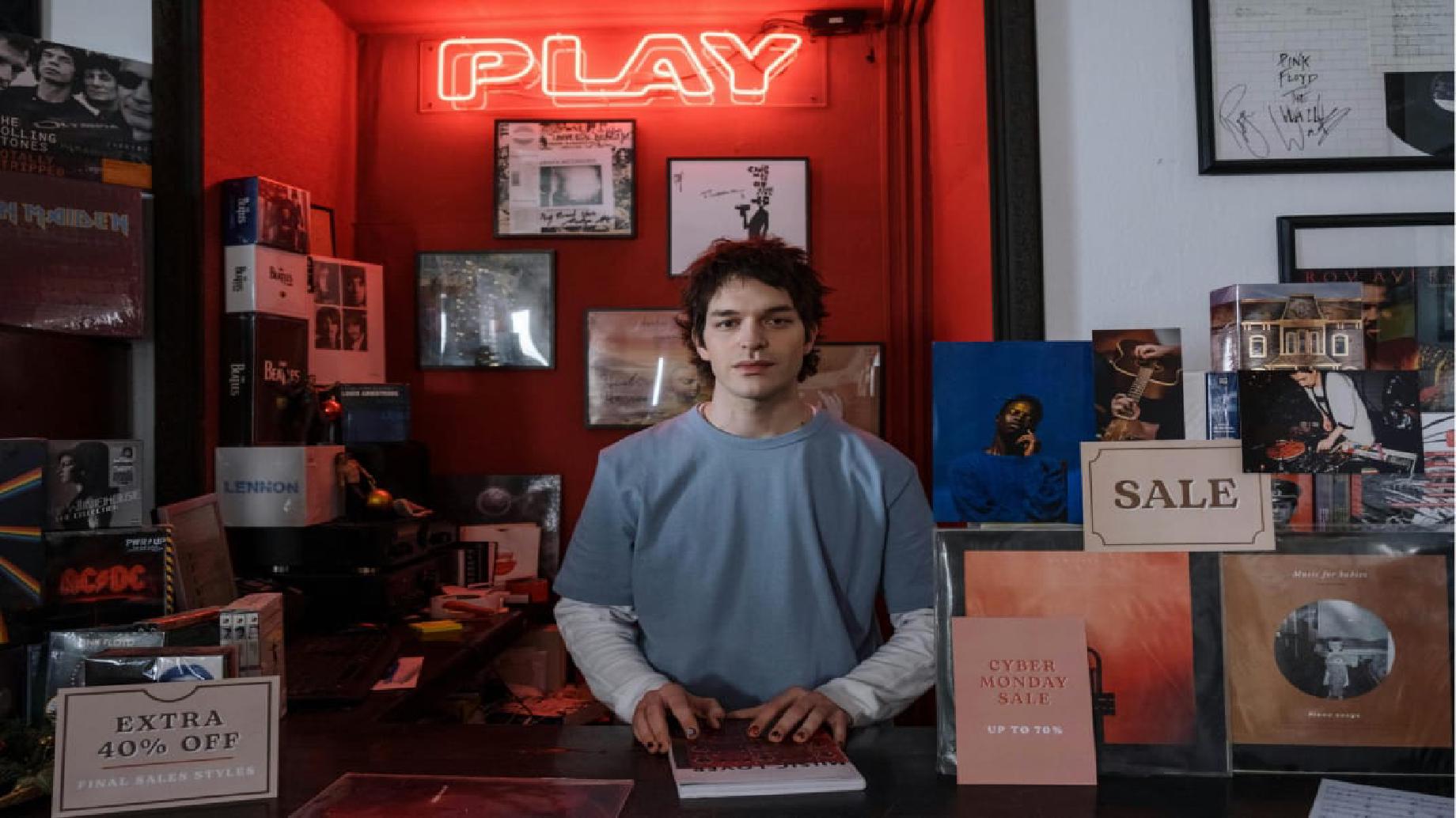 Man behind the counter of a record store