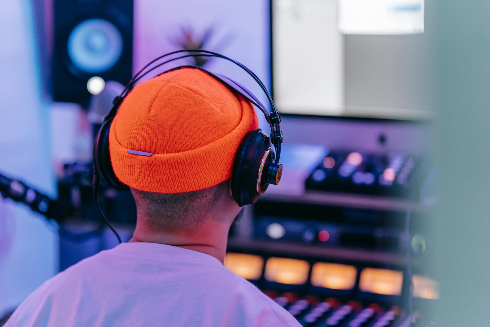 Photo of someone listening to music with headphones from behind