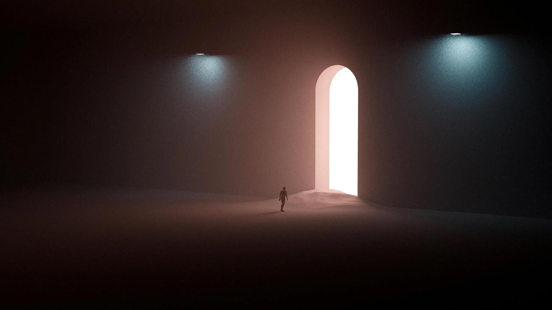 Silhouette of a man walking into a door of light
