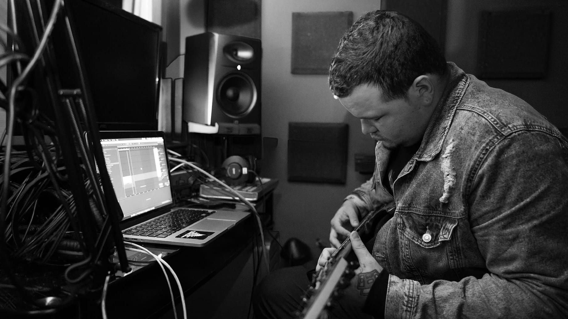 man making music in front of computer
