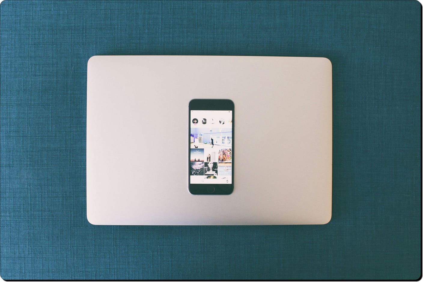 Phone placed on top of closed laptop