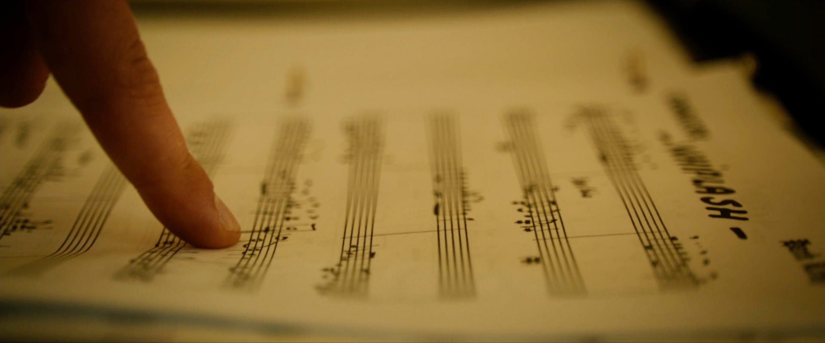 Finger pointing at some sheet music