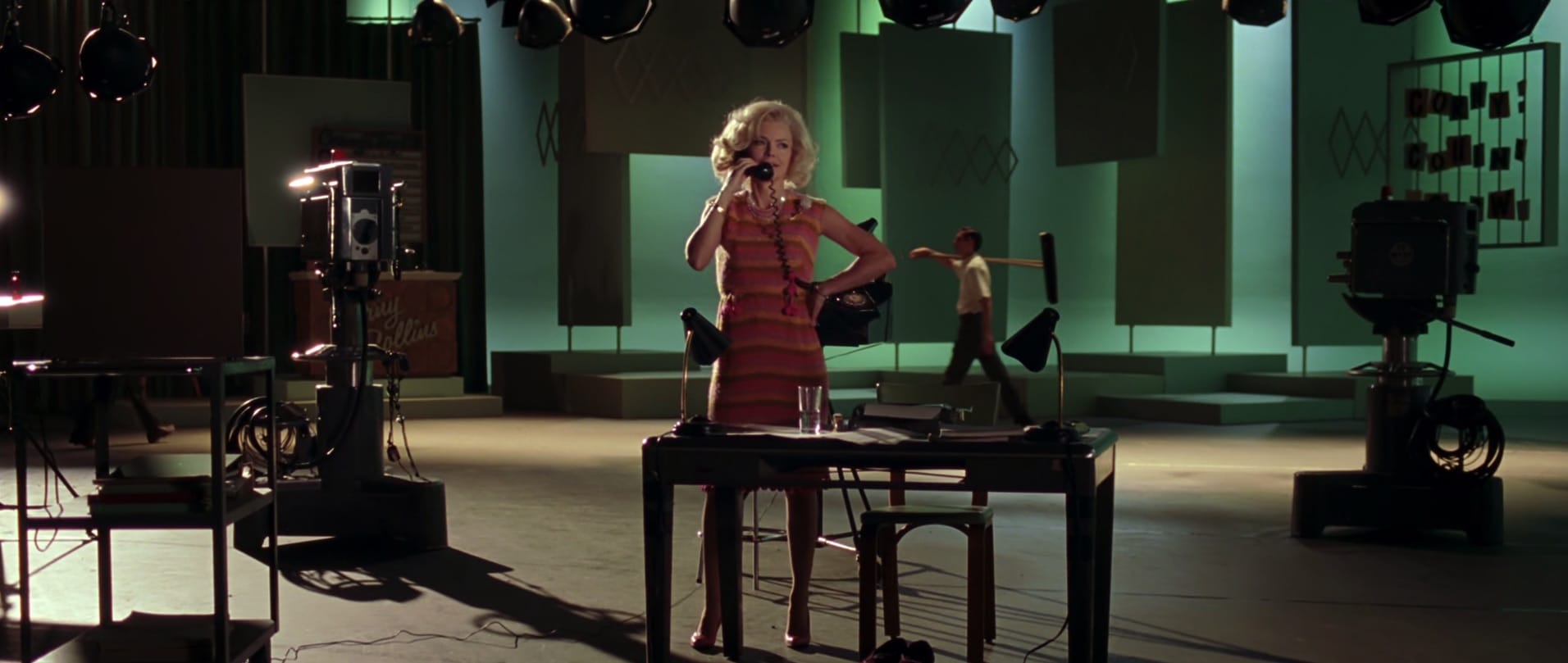 Woman on a movie set talking to someone on the phone