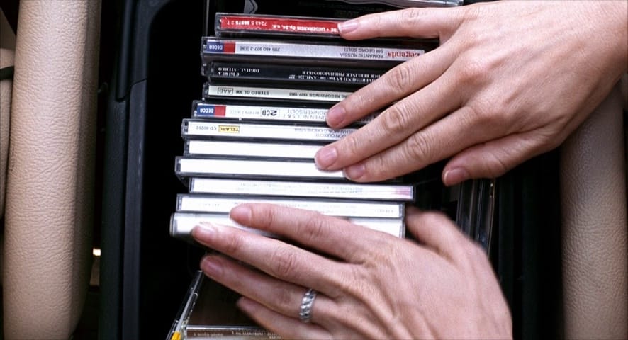 Picture of hands going through a pile of CD
