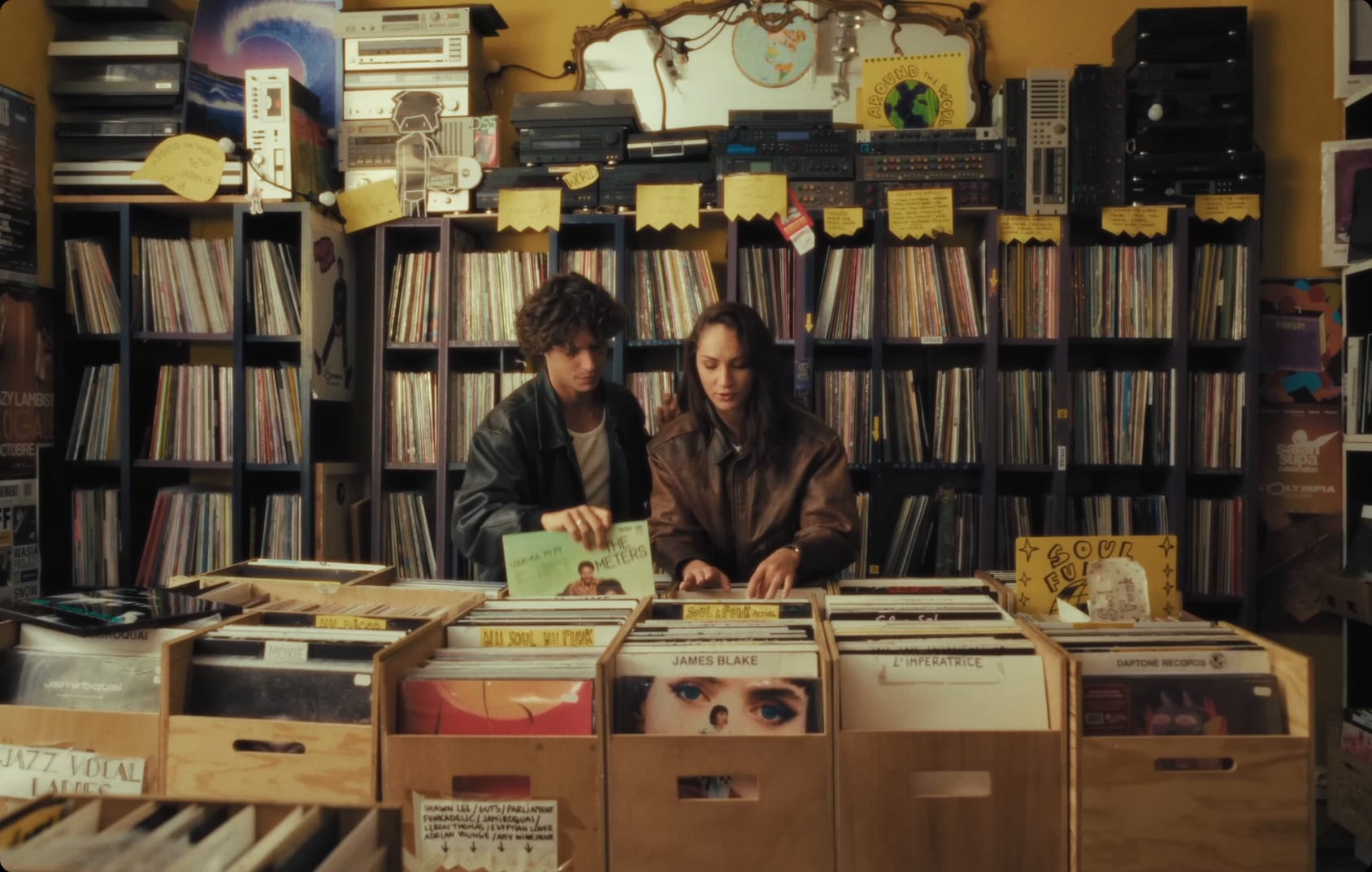 Two people listening to vinyls in a record store